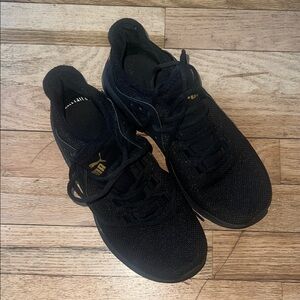 Puma women’s  Black and Gold Athletic Shoes